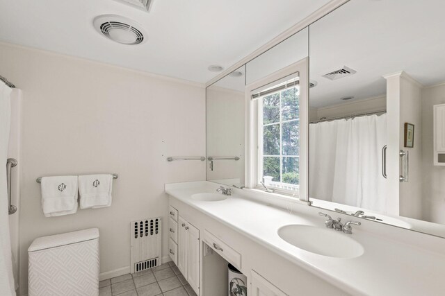 laundry area with crown molding, washer and clothes dryer, and cabinets