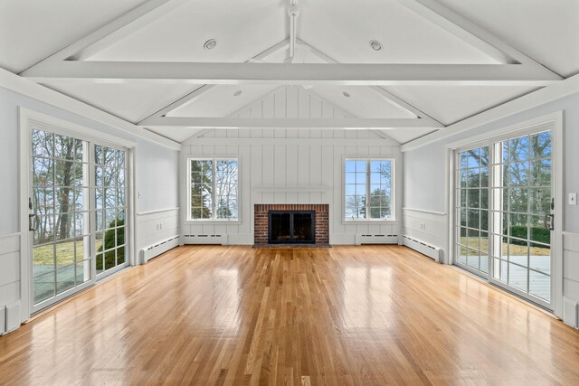 dining area featuring crown molding, a baseboard radiator, a brick fireplace, and light tile patterned floors