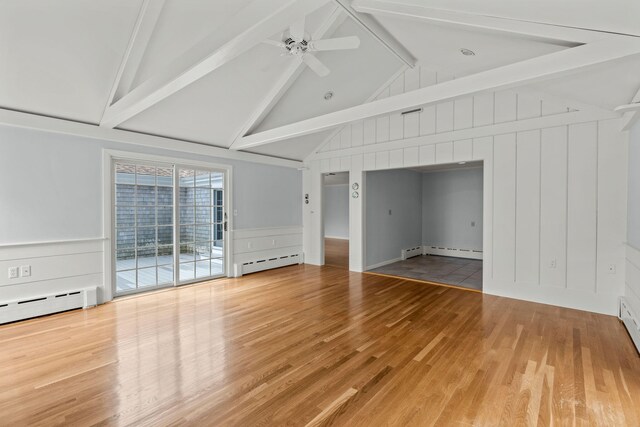 entryway with a baseboard radiator, ornamental molding, light wood-type flooring, and a wealth of natural light