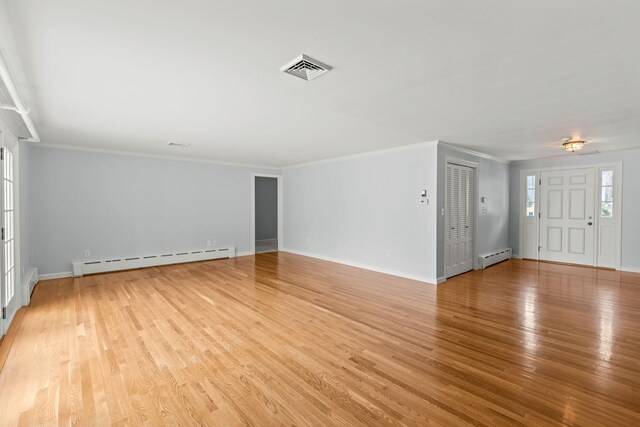 living room with hardwood / wood-style floors, plenty of natural light, vaulted ceiling with beams, and a brick fireplace