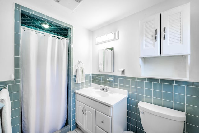 38 Rainbow Way, Harwich, MA 02645 - full bathroom with a shower with curtain, toilet, tile walls, wainscoting, and vanity