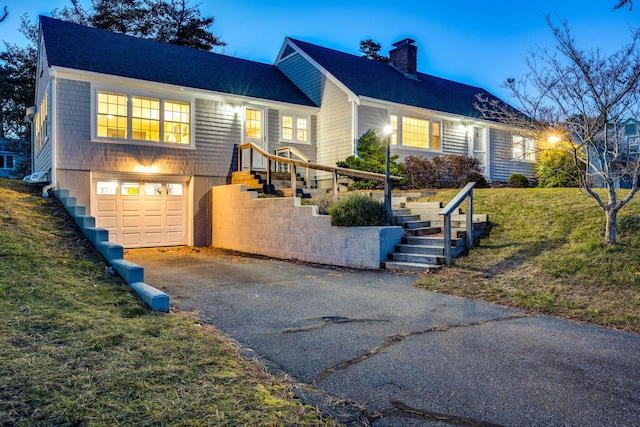 38 Rainbow Way, Harwich, MA 02645 - view of front of house featuring a front lawn, driveway, a chimney, a garage, and stairs