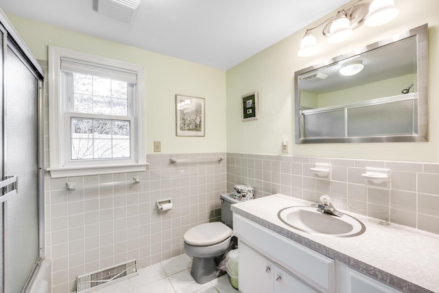 38 Rainbow Way, Harwich, MA 02645 - full bath with tile patterned floors, vanity, tile walls, toilet, and visible vents