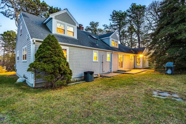 38 Rainbow Way, Harwich, MA 02645 - rear view of property featuring a yard, roof with shingles, and a chimney