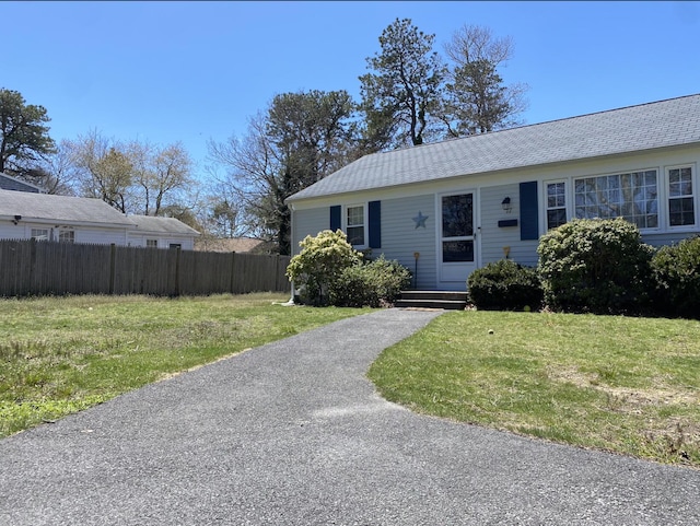 ranch-style home with a front lawn