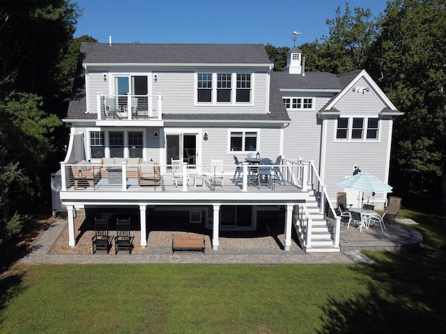 rear view of property with a balcony, a yard, an outdoor hangout area, and a patio area