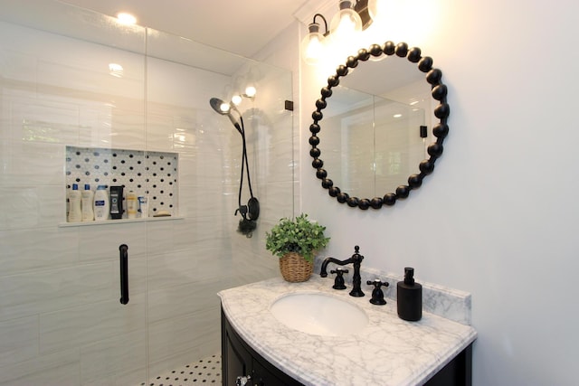 bathroom with an enclosed shower and vanity