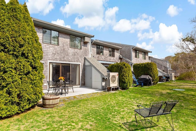 rear view of property with a yard and a patio area