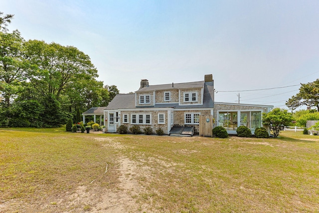 36 Uncle Barneys Rd, West Dennis, MA 02670 - shingle-style home with a front lawn, a sunroom, and a chimney