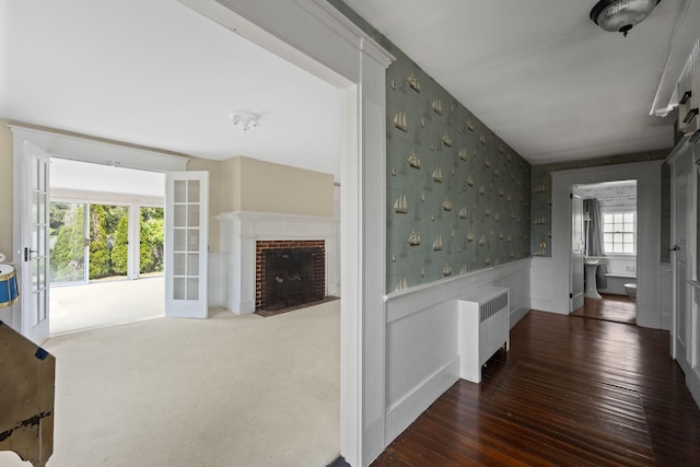 36 Uncle Barneys Rd, West Dennis, MA 02670 - hall featuring wallpapered walls, radiator, and hardwood / wood-style floors