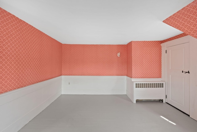 36 Uncle Barneys Rd, West Dennis, MA 02670 - empty room with radiator heating unit, wallpapered walls, and wainscoting