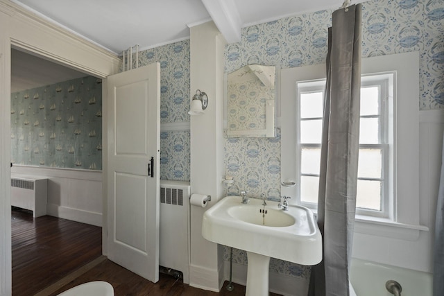 36 Uncle Barneys Rd, West Dennis, MA 02670 - bathroom featuring wallpapered walls, radiator heating unit, wood finished floors, wainscoting, and ornamental molding