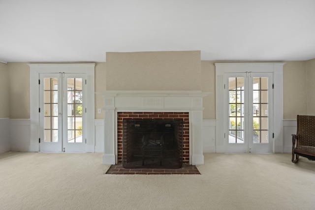 36 Uncle Barneys Rd, West Dennis, MA 02670 - carpeted living room with a wainscoted wall and a fireplace with flush hearth