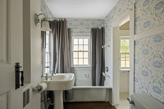 36 Uncle Barneys Rd, West Dennis, MA 02670 - bathroom with wallpapered walls, shower / tub combo with curtain, and wood finished floors