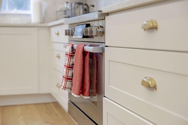 details featuring white cabinets and light hardwood / wood-style flooring