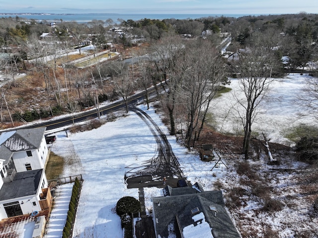 snowy aerial view with a water view