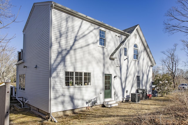 rear view of house featuring central AC