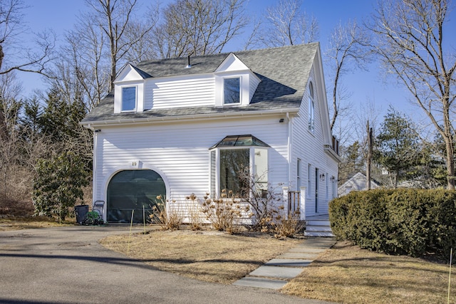 new england style home featuring a garage