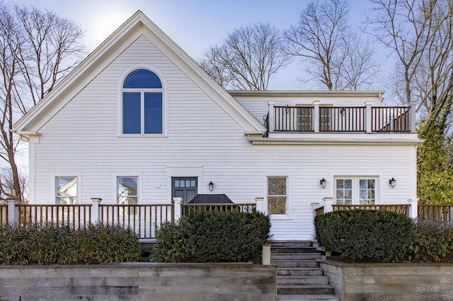 back of property featuring a balcony