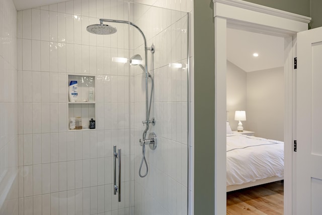 bathroom featuring a shower with door and hardwood / wood-style flooring