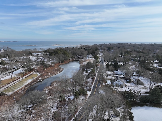 snowy aerial view with a water view