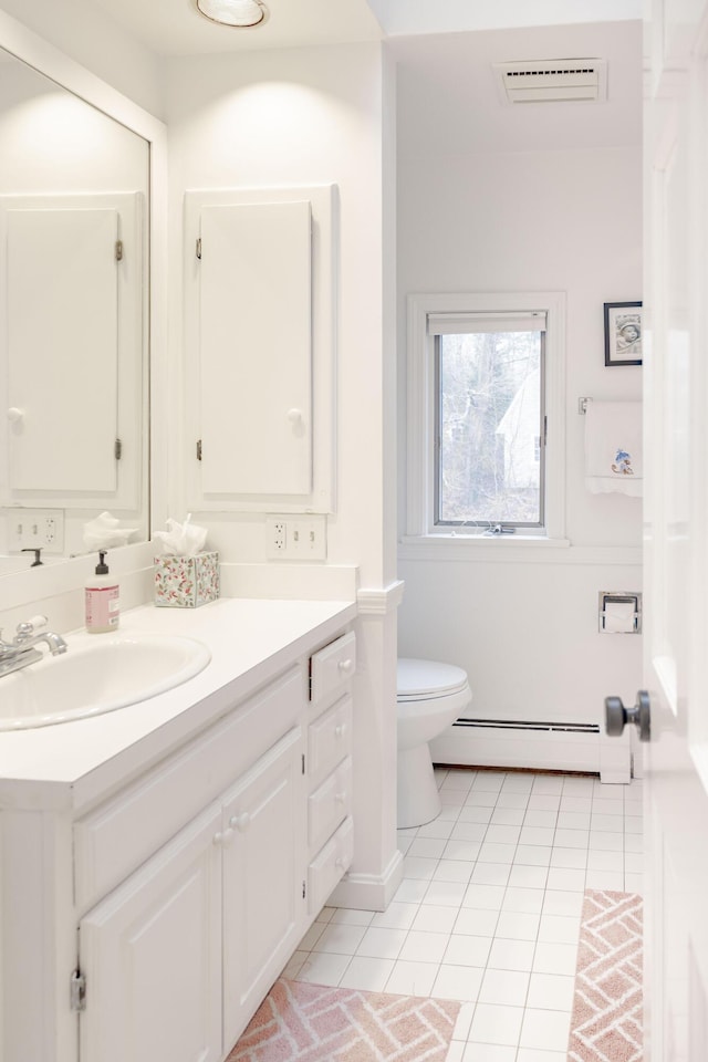 bathroom with vanity, tile patterned flooring, toilet, and baseboard heating