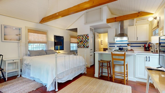 bedroom featuring wood-type flooring and lofted ceiling with beams