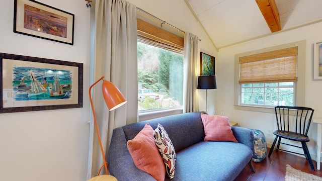 living area featuring dark wood-type flooring and vaulted ceiling with beams