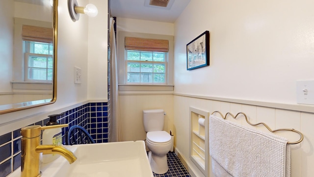 bathroom with sink, toilet, and tile patterned floors