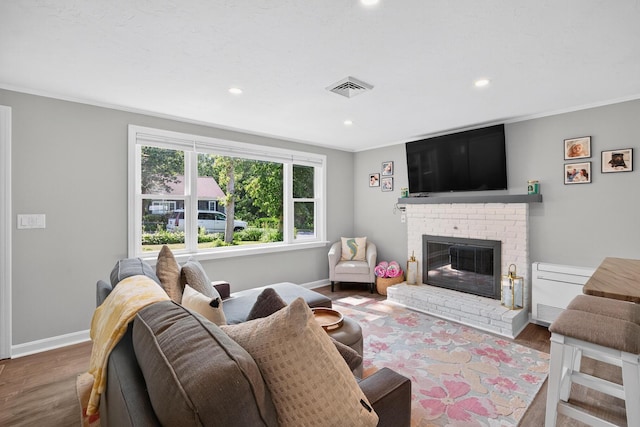 24 Tabor Rd, Forestdale, MA 02644 - living room with wood finished floors, a fireplace, recessed lighting, and crown molding