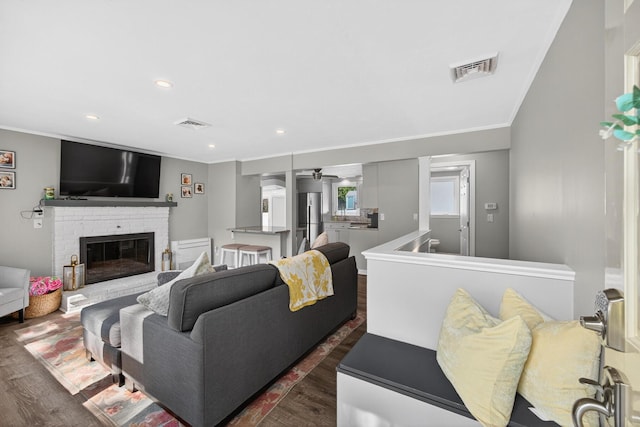 24 Tabor Rd, Forestdale, MA 02644 - living area with ornamental molding, dark wood-style flooring, a fireplace, recessed lighting, and a ceiling fan