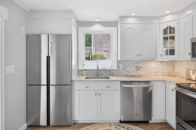24 Tabor Rd, Forestdale, MA 02644 - kitchen with stainless steel appliances, white cabinets, glass insert cabinets, backsplash, and wood finished floors