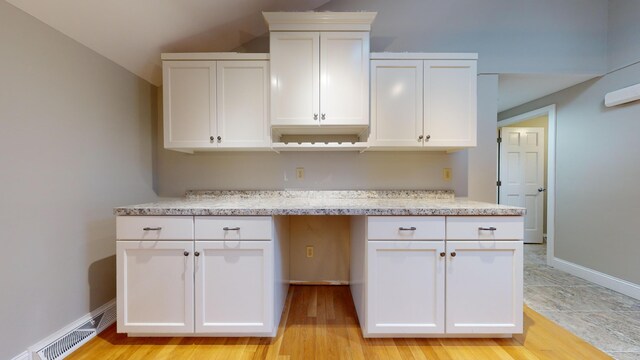 kitchen featuring white cabinetry and light hardwood / wood-style flooring