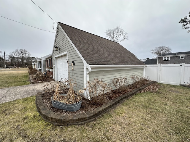 view of side of home with a garage and a yard