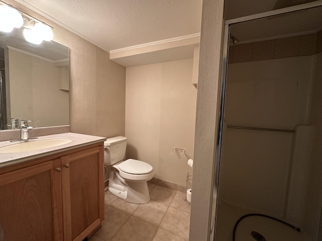 bathroom featuring tile patterned floors, a shower with door, vanity, toilet, and ornamental molding