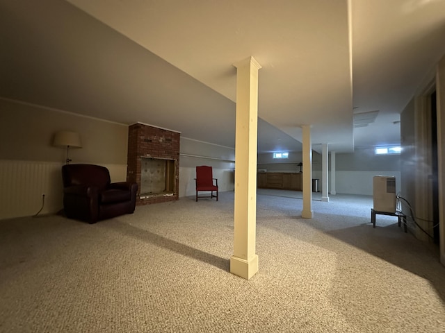 basement with carpet and a fireplace