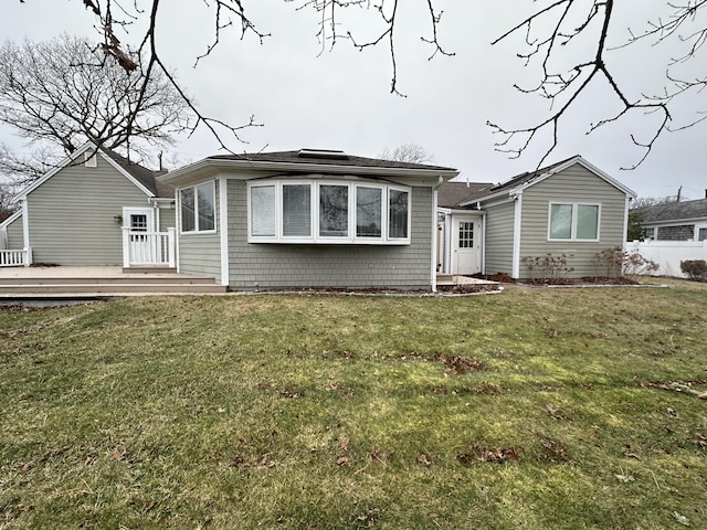 view of front of house featuring a front yard and a deck