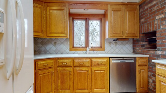 kitchen featuring sink, backsplash, stainless steel dishwasher, and white fridge