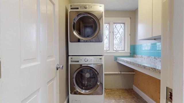 laundry room with stacked washing maching and dryer