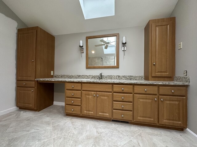 bathroom featuring vanity and a skylight