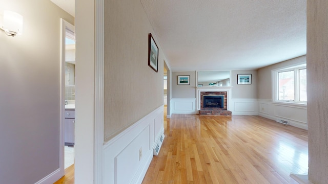 unfurnished living room with light hardwood / wood-style flooring and a fireplace