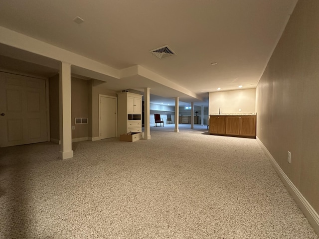 basement featuring light colored carpet