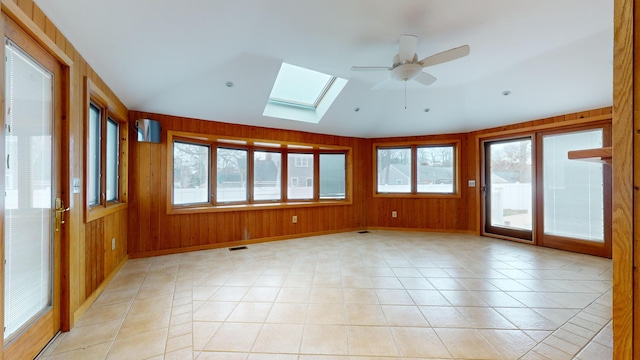 unfurnished sunroom featuring a skylight and ceiling fan