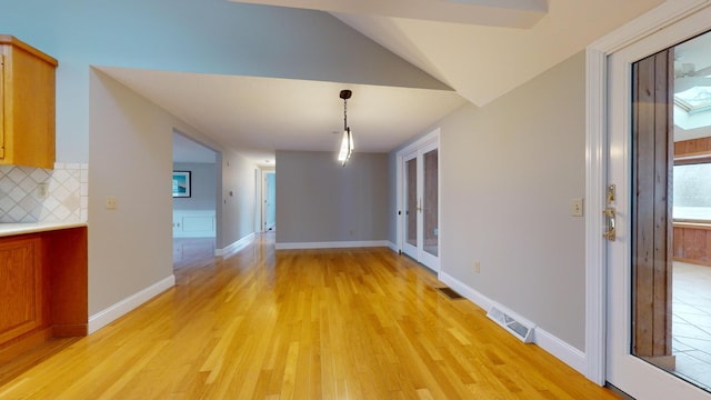 interior space with light hardwood / wood-style floors and vaulted ceiling