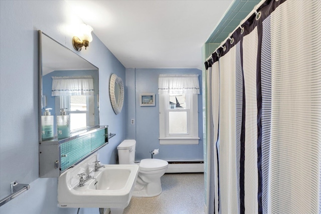 bathroom featuring a baseboard radiator, toilet, and curtained shower