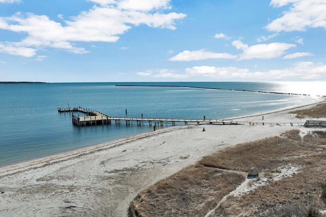 property view of water with a dock and a view of the beach