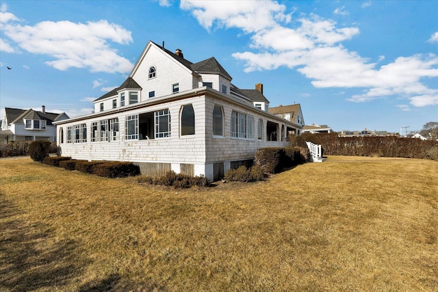 view of side of home featuring a yard