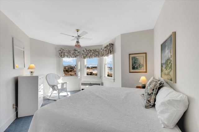 carpeted bedroom featuring ceiling fan and radiator