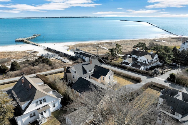 drone / aerial view featuring a water view and a view of the beach