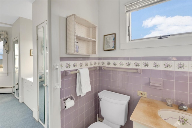 bathroom with tile walls, toilet, and vanity